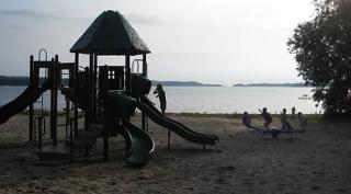 Children playing on playground by the beach